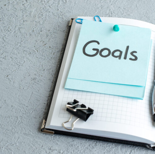 front-view-goals-written-note-with-pen-white-background